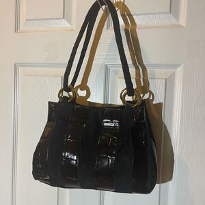 Lacovina leather /suede black medium shoulder Bag with gold tone ring accents .